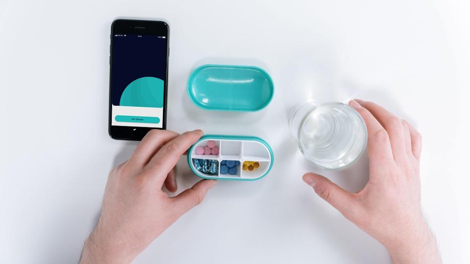 A smartphone medication app alongside a connected pill dispenser